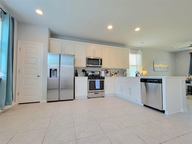 1765 Yaupon Grove Ln, Leander, TX 78641 - kitchen with appliances with stainless steel finishes, white cabinets, a peninsula, decorative backsplash, and recessed lighting