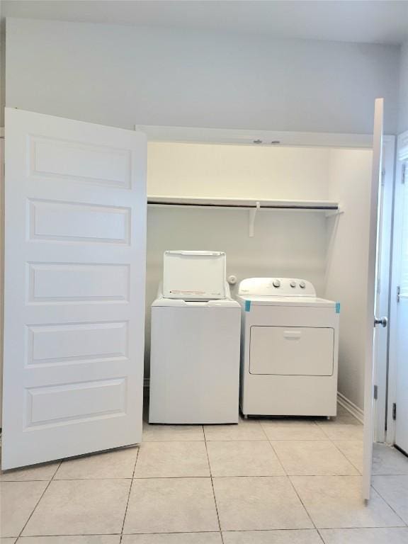 1765 Yaupon Grove Ln, Leander, TX 78641 - washroom featuring washing machine and dryer and light tile patterned floors