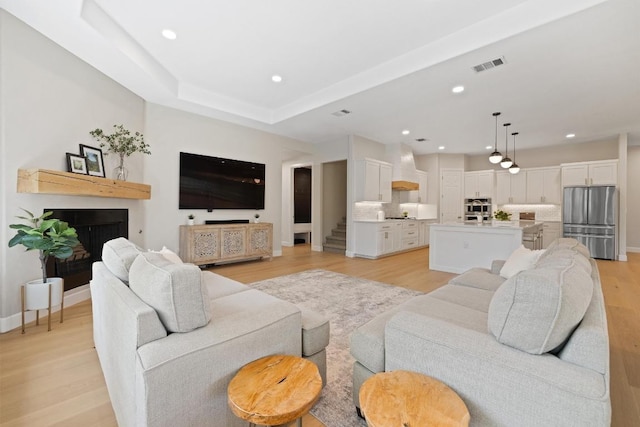 113 Oak Plaza Dr, Georgetown, TX 78628 - living area with visible vents, light wood-style flooring, recessed lighting, and a fireplace