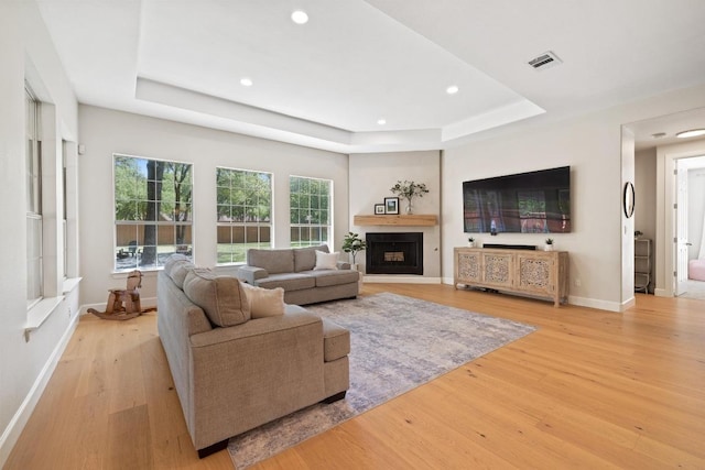 113 Oak Plaza Dr, Georgetown, TX 78628 - living area with recessed lighting, a raised ceiling, baseboards, and wood finished floors