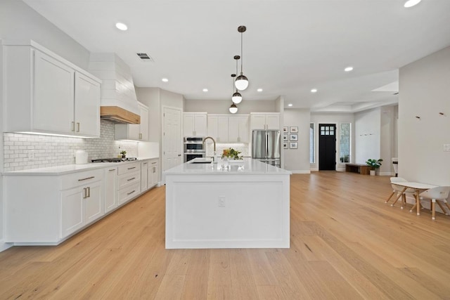 113 Oak Plaza Dr, Georgetown, TX 78628 - kitchen featuring visible vents, decorative backsplash, white cabinetry, and stainless steel appliances