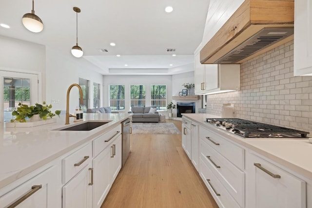 113 Oak Plaza Dr, Georgetown, TX 78628 - kitchen featuring a sink, light countertops, appliances with stainless steel finishes, under cabinet range hood, and recessed lighting