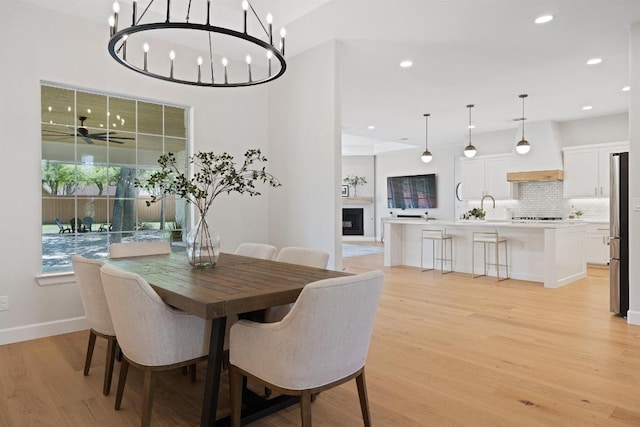 113 Oak Plaza Dr, Georgetown, TX 78628 - dining area featuring baseboards, light wood finished floors, and recessed lighting