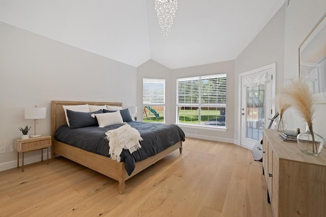 113 Oak Plaza Dr, Georgetown, TX 78628 - bedroom with baseboards, an inviting chandelier, light wood-style floors, and lofted ceiling