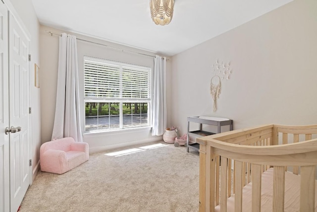 113 Oak Plaza Dr, Georgetown, TX 78628 - bedroom featuring a nursery area, baseboards, and carpet flooring
