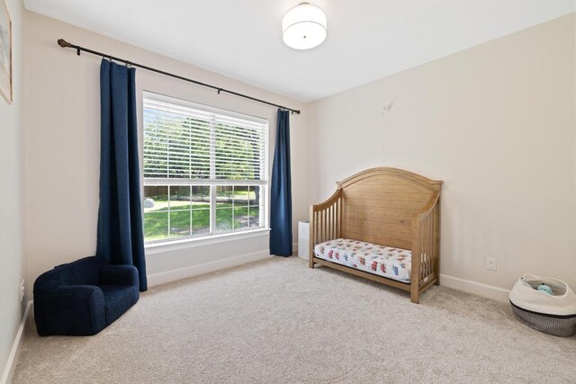 113 Oak Plaza Dr, Georgetown, TX 78628 - bedroom with carpet flooring, baseboards, and a crib