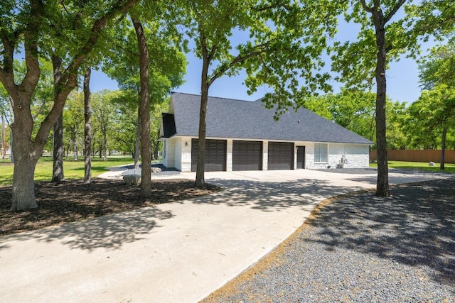 113 Oak Plaza Dr, Georgetown, TX 78628 - view of front of home with concrete driveway, stone siding, a garage, and a shingled roof
