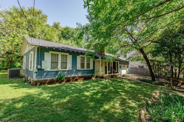 1010 Avondale Rd, Austin, TX 78704 - view of front of house with central air condition unit, a front lawn, and an attached garage