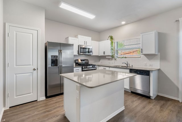 10805 Dimitrios Dr, Austin, TX 78747 - kitchen with appliances with stainless steel finishes, decorative backsplash, wood finished floors, and recessed lighting