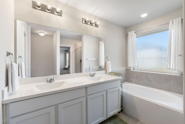 10805 Dimitrios Dr, Austin, TX 78747 - bathroom featuring double vanity, a bath, a shower stall, and tile patterned flooring