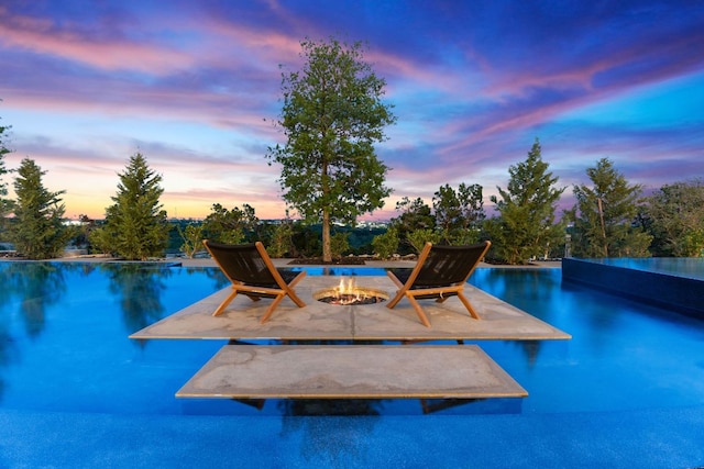 4816 Pecan Chase, Austin, TX 78738 - pool at dusk with a fire pit and a patio
