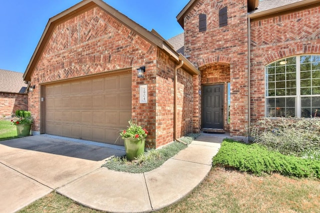 1904 Cactus Mound Dr, Leander, TX 78641 - view of front of home with brick siding, an attached garage, driveway, and a shingled roof