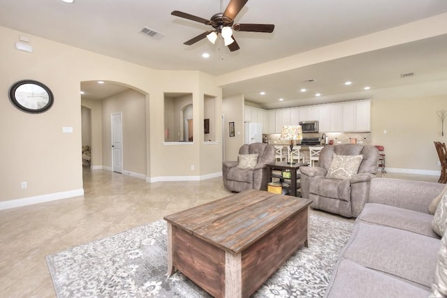 1904 Cactus Mound Dr, Leander, TX 78641 - living room with a ceiling fan, arched walkways, and recessed lighting