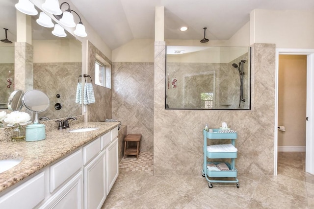 1904 Cactus Mound Dr, Leander, TX 78641 - bathroom featuring tile walls, walk in shower, double vanity, and lofted ceiling