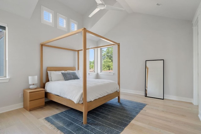 bedroom with wood finished floors, baseboards, high vaulted ceiling, and ceiling fan