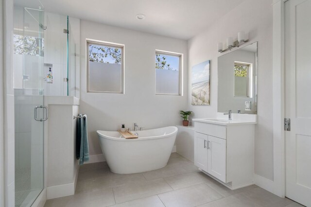 4502 Banister Ln Unit 1, Austin, TX 78745 - bathroom featuring a shower stall, baseboards, vanity, and a freestanding bath