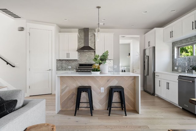 4502 Banister Ln Unit 1, Austin, TX 78745 - kitchen with wall chimney exhaust hood, appliances with stainless steel finishes, a sink, separate washer and dryer, and backsplash