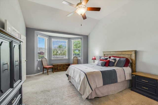 bedroom with light carpet, baseboards, a ceiling fan, and lofted ceiling