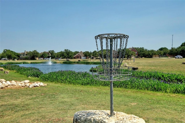 view of property's community featuring a yard and a water view