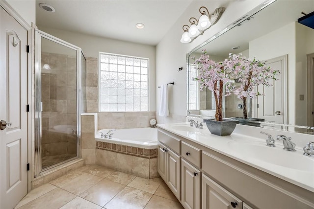 bathroom with a garden tub, a stall shower, and a sink
