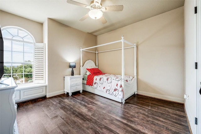 bedroom featuring ceiling fan, baseboards, and wood finished floors