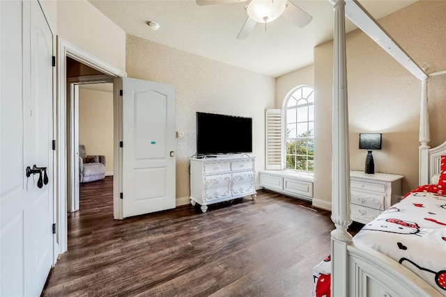 bedroom featuring baseboards, a ceiling fan, and dark wood-style floors
