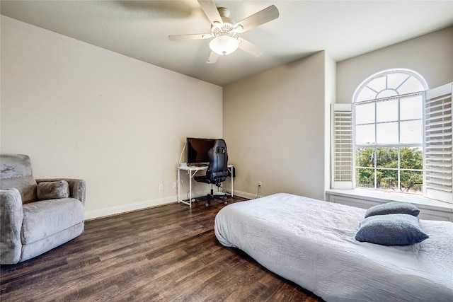 bedroom with ceiling fan, baseboards, multiple windows, and wood finished floors