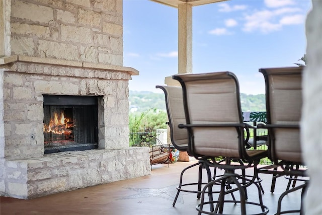 view of patio featuring an outdoor stone fireplace