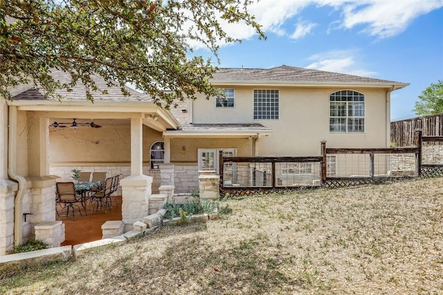 back of house featuring a patio area, stucco siding, and fence