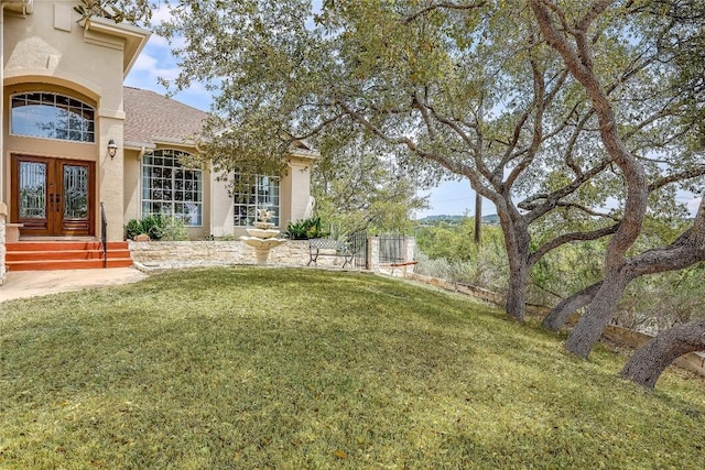 view of yard featuring french doors