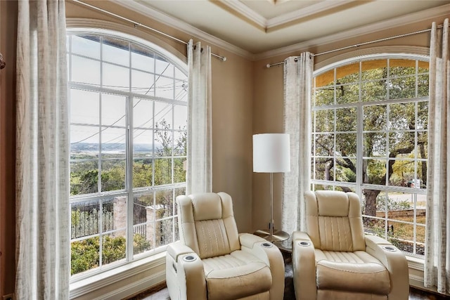 living area with plenty of natural light and ornamental molding
