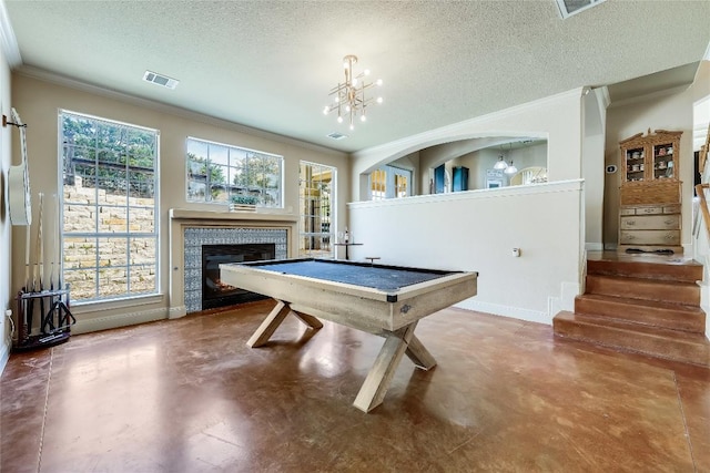 recreation room with ornamental molding, concrete flooring, and visible vents