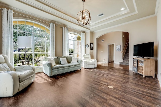 21735 Sierra Trl, Lago Vista, TX 78645 - living area with crown molding, a raised ceiling, a chandelier, stairway, and arched walkways