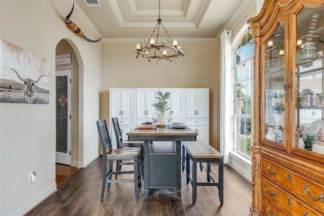 21735 Sierra Trl, Lago Vista, TX 78645 - dining room featuring arched walkways, a chandelier, dark wood-type flooring, a raised ceiling, and crown molding