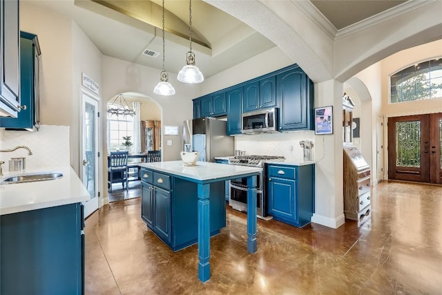 21735 Sierra Trl, Lago Vista, TX 78645 - kitchen featuring blue cabinets, arched walkways, stainless steel appliances, tasteful backsplash, and a kitchen island