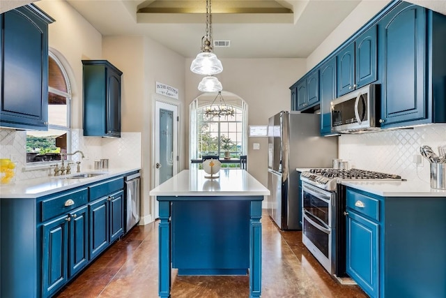 21735 Sierra Trl, Lago Vista, TX 78645 - kitchen with blue cabinetry, stainless steel appliances, a center island, and tasteful backsplash