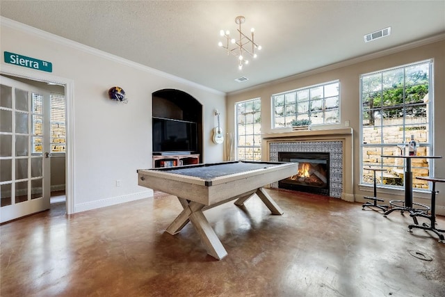 21735 Sierra Trl, Lago Vista, TX 78645 - rec room featuring finished concrete floors, crown molding, a tile fireplace, and a chandelier