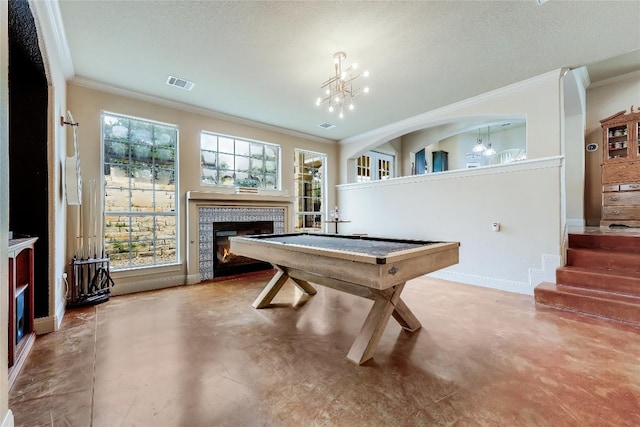 21735 Sierra Trl, Lago Vista, TX 78645 - game room featuring concrete flooring, a tiled fireplace, crown molding, a chandelier, and a textured ceiling