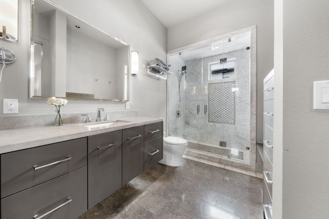 full bathroom featuring a stall shower, vanity, and toilet
