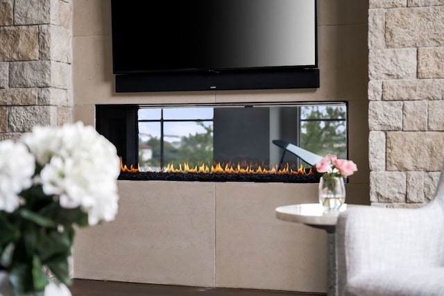 interior details featuring a glass covered fireplace
