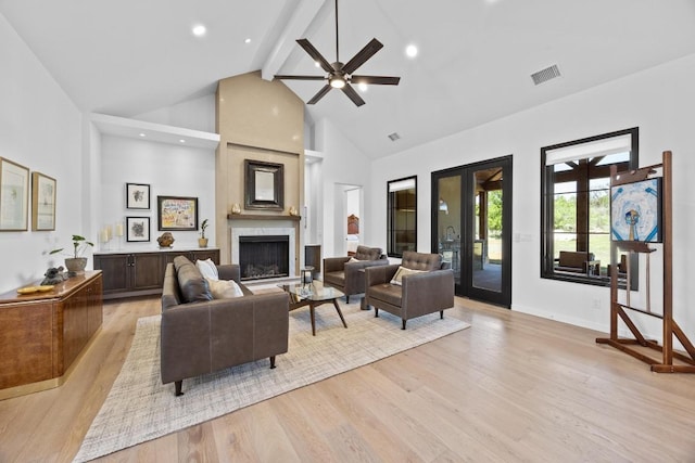 4010 County Road 404, Spicewood, TX 78669 - living area featuring high vaulted ceiling, beam ceiling, light wood finished floors, ceiling fan, and a premium fireplace