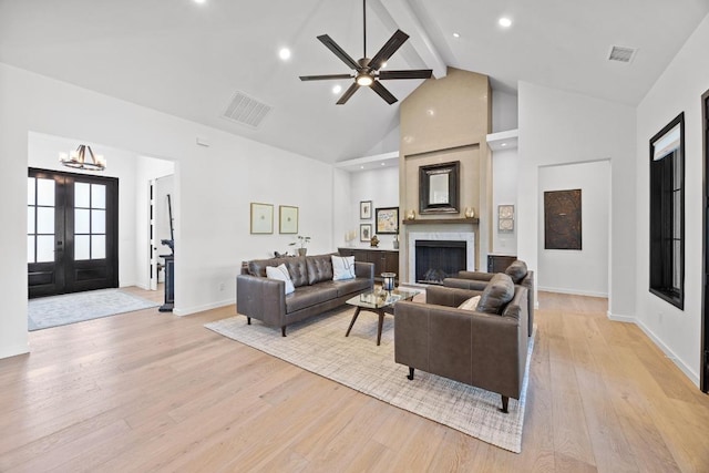 4010 County Road 404, Spicewood, TX 78669 - living room with beam ceiling, light wood finished floors, high vaulted ceiling, baseboards, and a fireplace