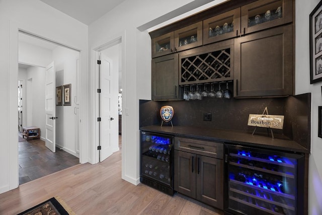 4010 County Road 404, Spicewood, TX 78669 - indoor dry bar featuring wine cooler, decorative backsplash, wood finished floors, and baseboards