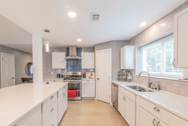 2400 Braemar Cv, Austin, TX 78747 - kitchen with wall chimney exhaust hood, appliances with stainless steel finishes, tasteful backsplash, light countertops, and recessed lighting