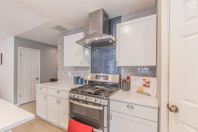 2400 Braemar Cv, Austin, TX 78747 - kitchen with stainless steel gas stove, wall chimney exhaust hood, tasteful backsplash, light countertops, and white cabinetry