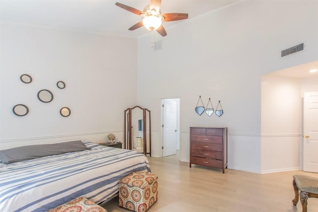 2400 Braemar Cv, Austin, TX 78747 - bedroom with light wood-style flooring, crown molding, and a ceiling fan