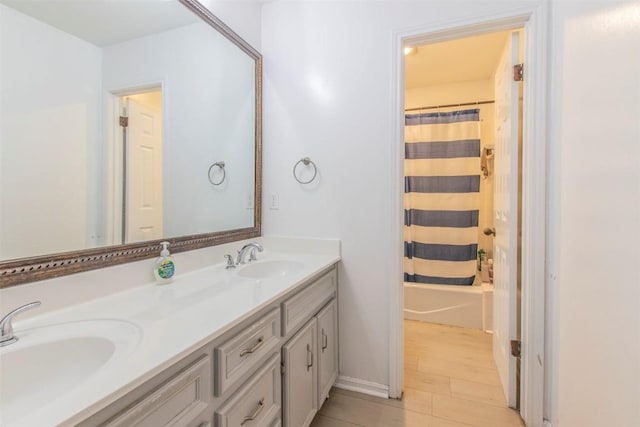 2400 Braemar Cv, Austin, TX 78747 - bathroom featuring double vanity, wood finished floors, and shower / bathtub combination with curtain
