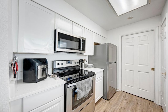 kitchen featuring white cabinetry, light countertops, and appliances with stainless steel finishes