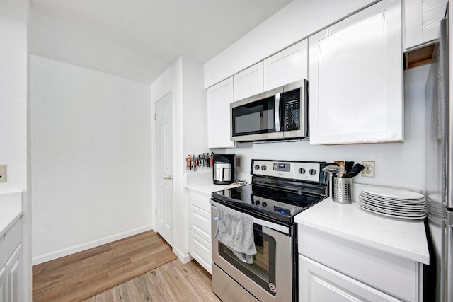 kitchen with white cabinets, light countertops, and stainless steel appliances