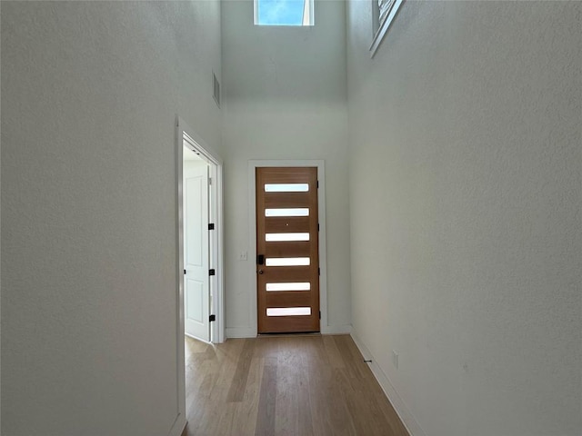12009 Cearley Dr, Austin, TX 78758 - doorway to outside with wood finished floors and a high ceiling